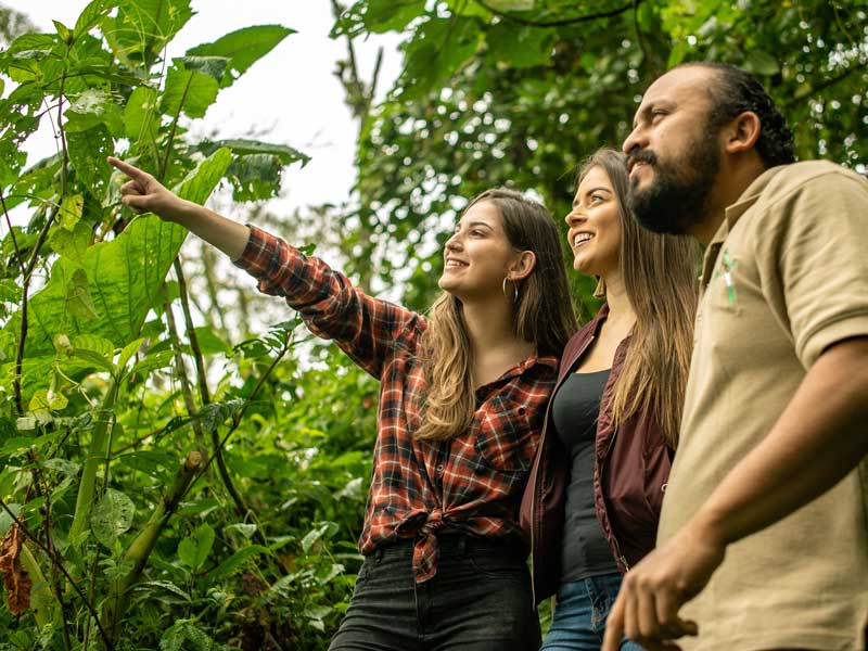 Un gruppo di persone in piedi l'una accanto all'altra in una foresta.