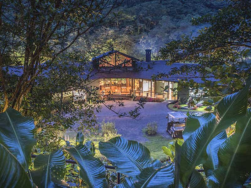 Una grande casa circondata da alberi verdeggianti.